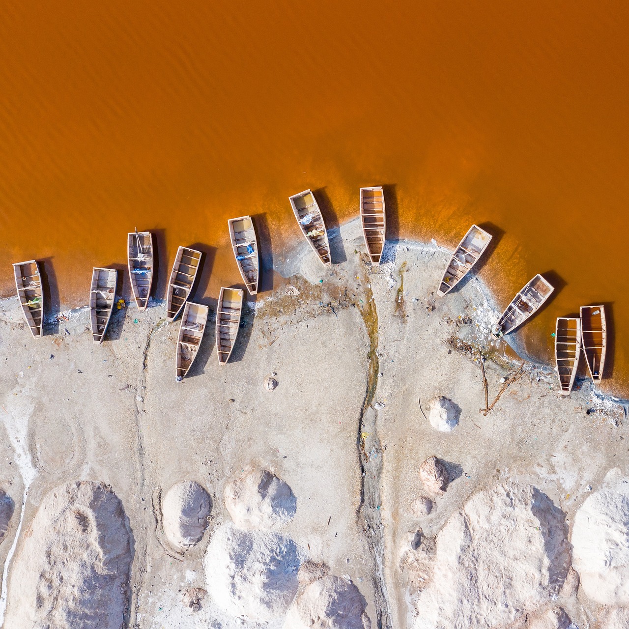 Vue aérienne d’embarcations et de dépôts de sel au bord d’un lac au Sénégal